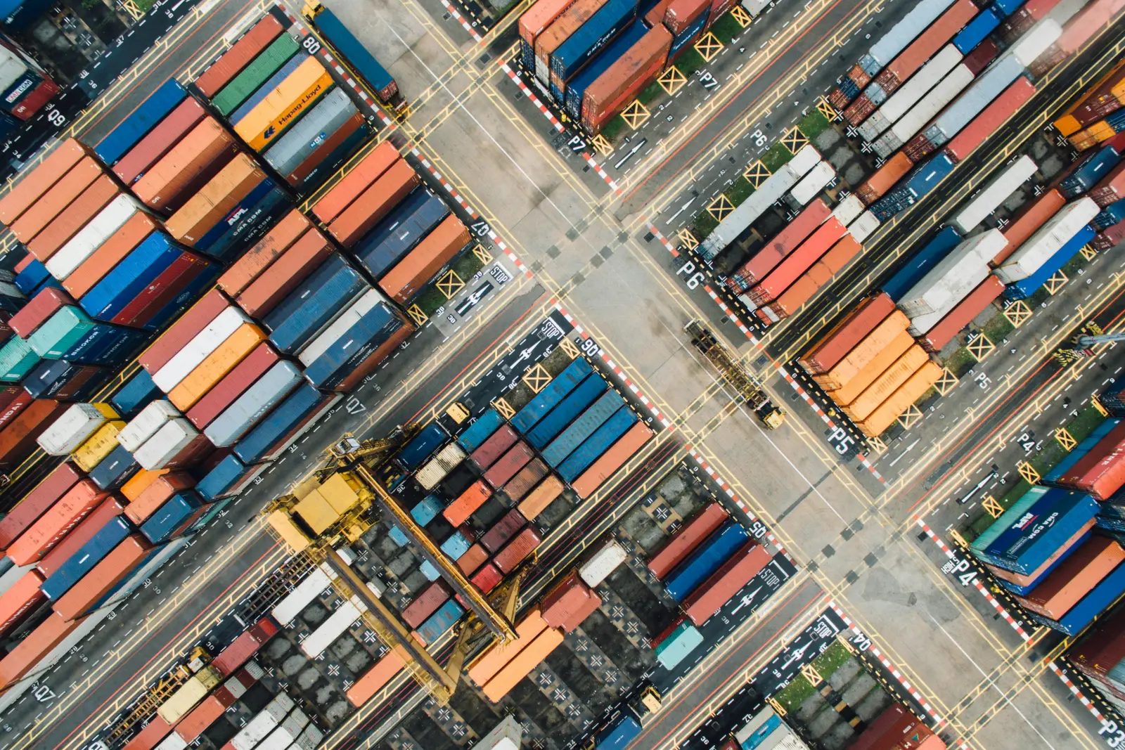 Container cranes at a busy export port at dusk